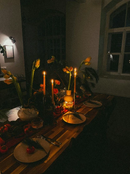 a wooden table topped with plates and candles, by Adam Marczyński, unsplash contest winner, renaissance, with yellow flowers around it, christmas night, room of a dark mansion, 🐿🍸🍋