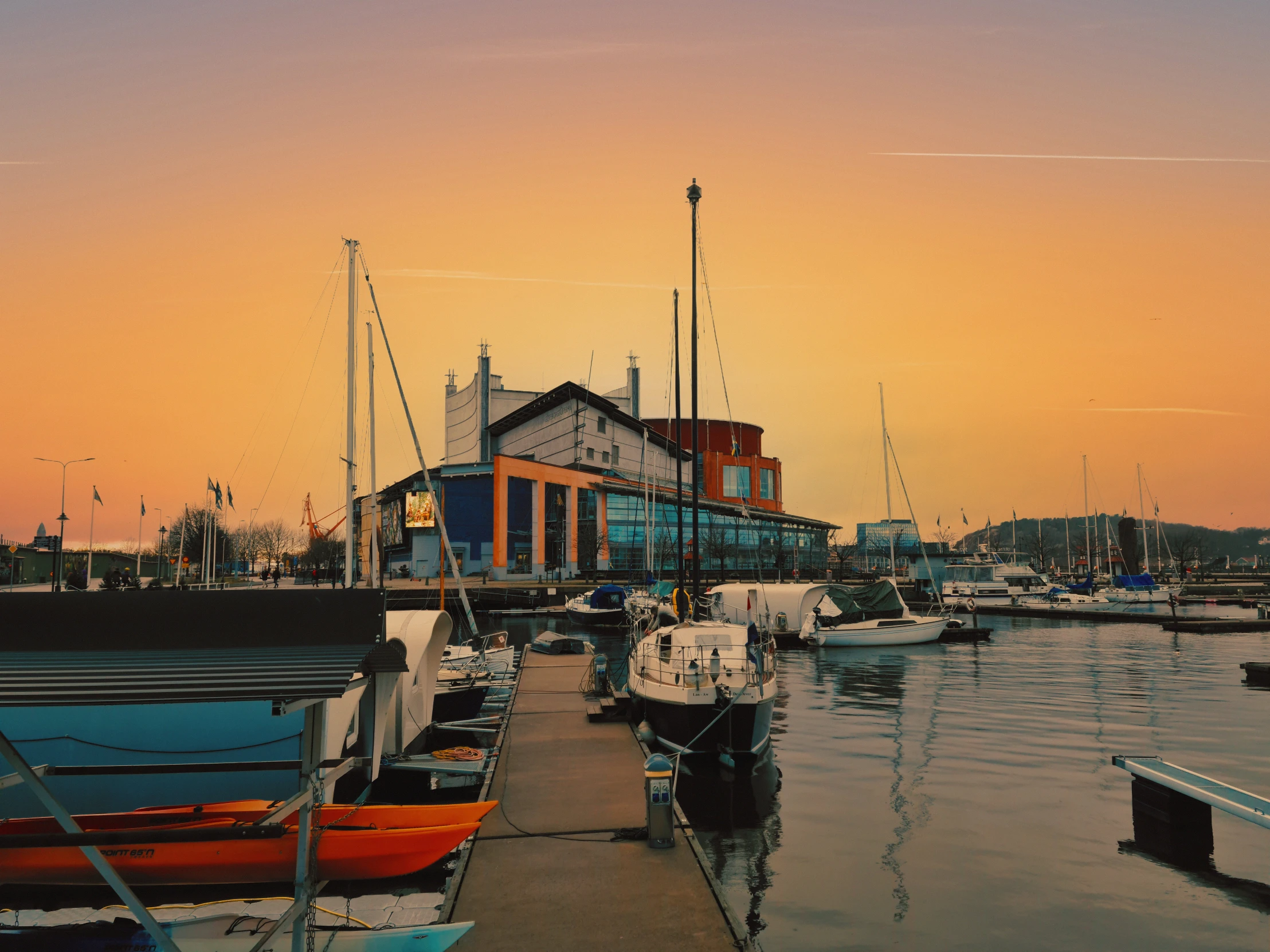 a number of boats in a body of water, a picture, inspired by Wilhelm Marstrand, pexels contest winner, peaceful evening harbor, hull is a opera house, warm coloured, family friendly