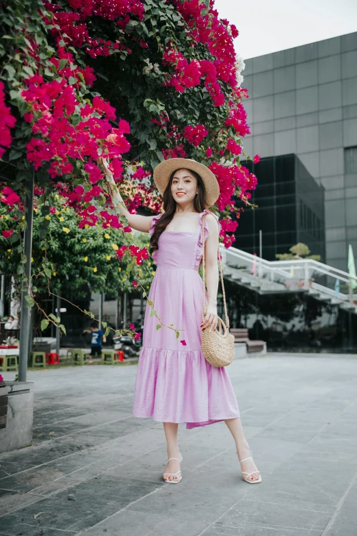 a woman in a pink dress and hat posing for a picture, pexels contest winner, ✨🕌🌙, singapore, wearing sundress, lilac