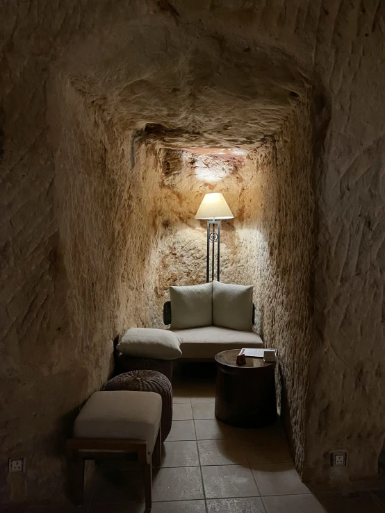 a room that has a couch and a lamp in it, an album cover, inspired by Jan Lievens, unsplash contest winner, natural cave wall, ww1 trench, narrow passage, from italica