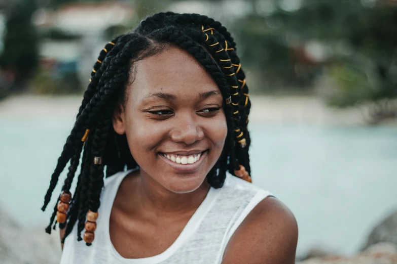 a woman with dreadlocks smiles at the camera, pexels contest winner, with black pigtails, profile image, avatar image, natural complexion