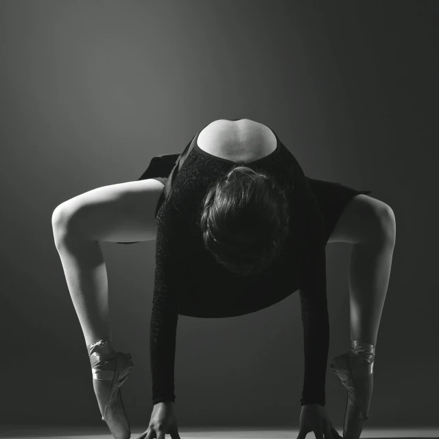 a woman in a black leo leo leo leo leo leo leo leo leo leo leo leo leo, a black and white photo, by Adam Marczyński, pexels contest winner, arabesque, bent over posture, istock, concept photo