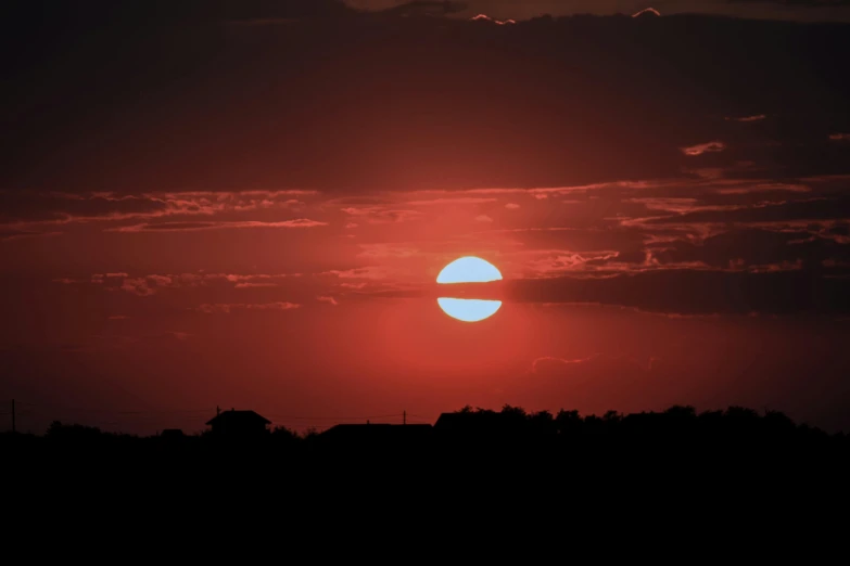 the sun is setting in the dark sky, pexels contest winner, big red sun, low iso, pink, low quality photo