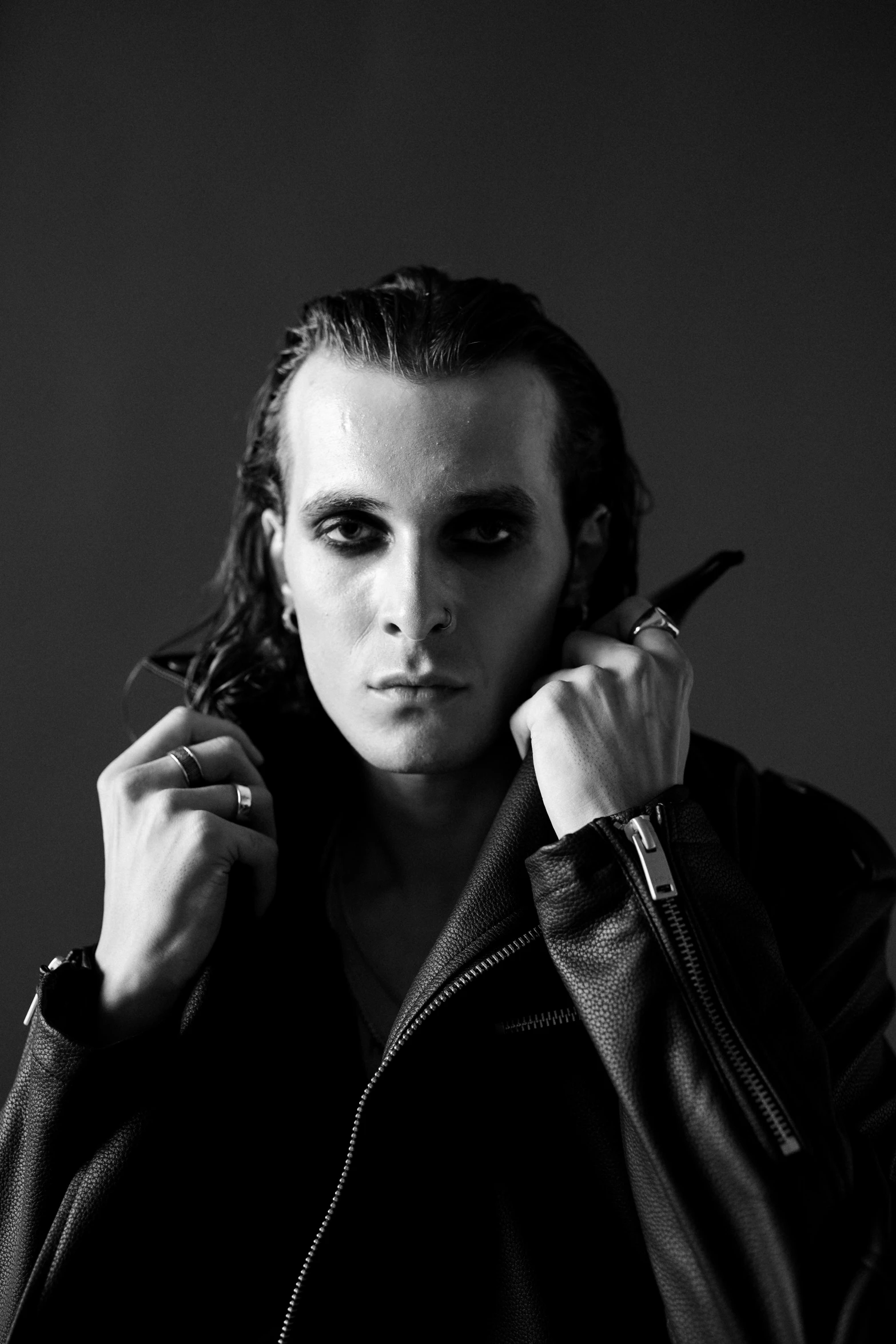 a man in a leather jacket smoking a cigarette, an album cover, inspired by Davide Sasselli, black eyes and large forehead, monochrome:-2, l vampire, low