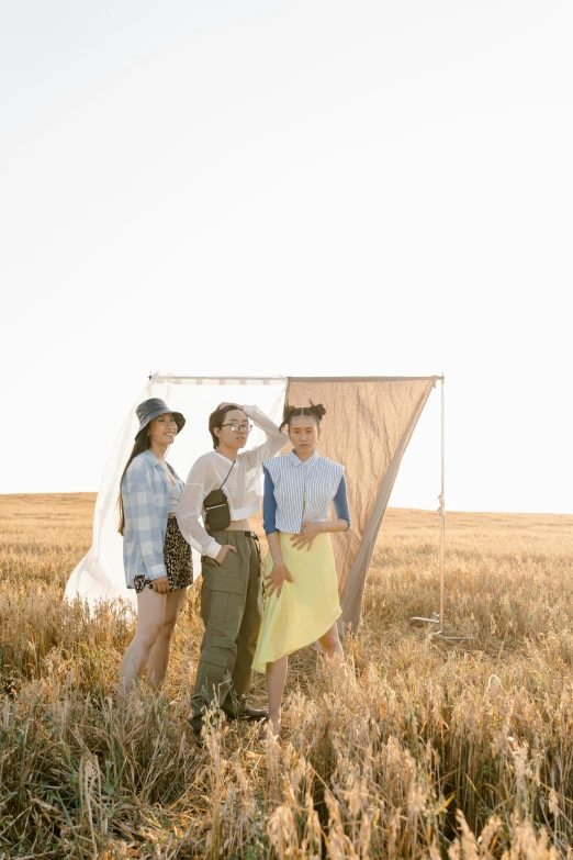 a group of people standing in a field, fashion pose, production photo, sail, wearing farm clothes