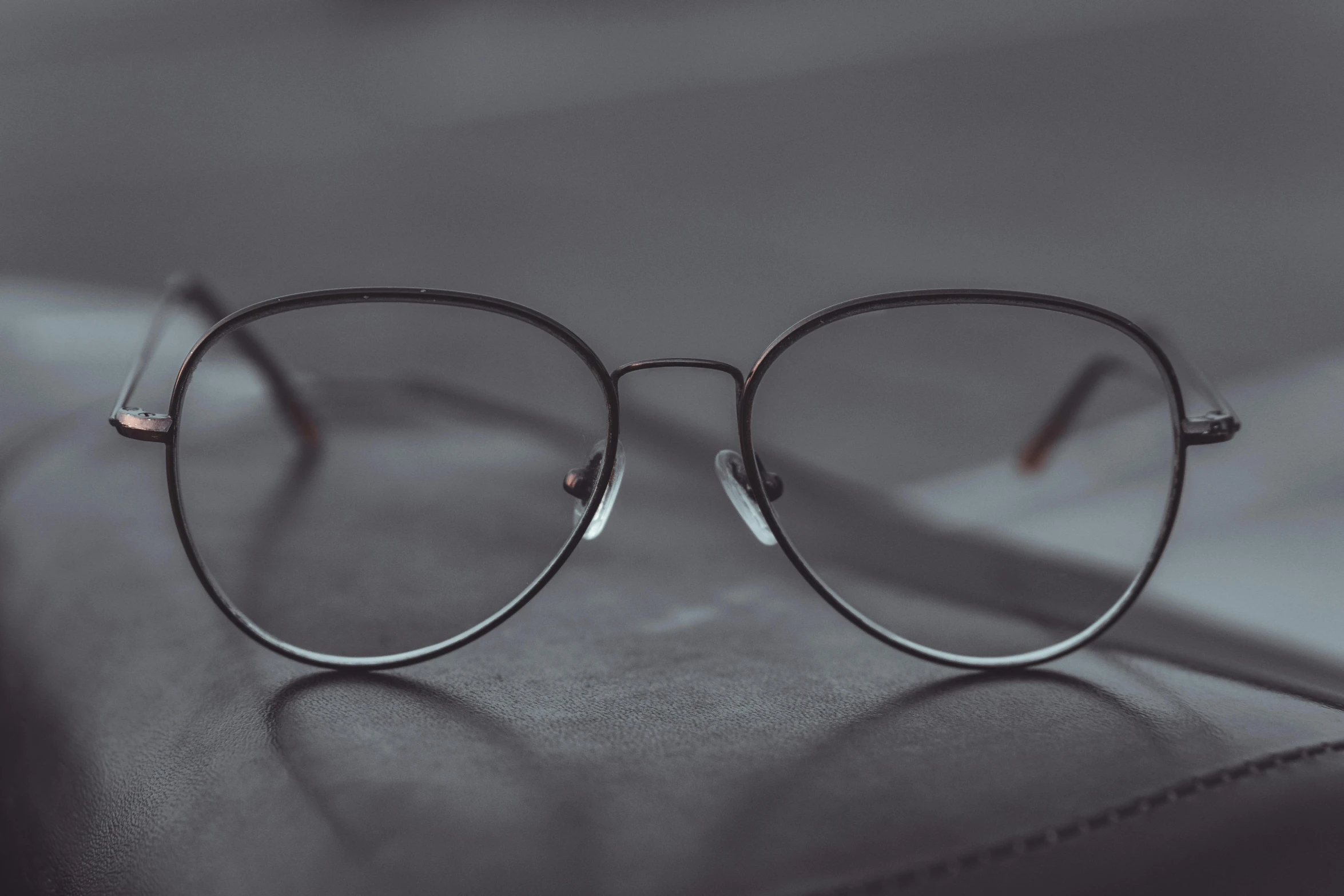 a pair of glasses sitting on top of a book