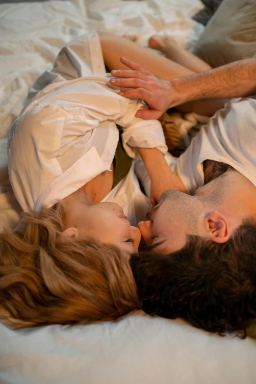 a man and a woman laying on top of a bed, inspired by Nan Goldin, trending on reddit, renaissance, medium closeup, touching, high angle, an attractive