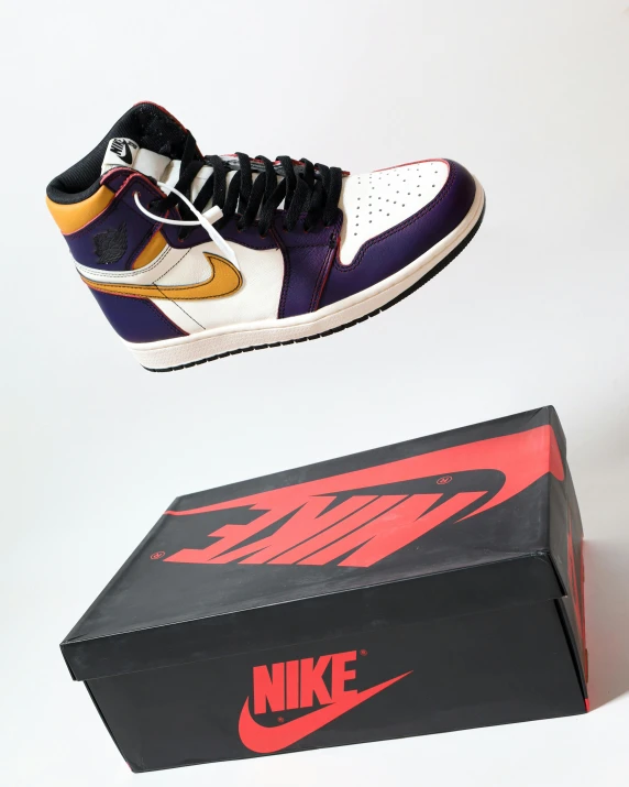 a pair of shoes sitting on top of a box, gold and purple, swoosh, reddit post, jumping towards viewer