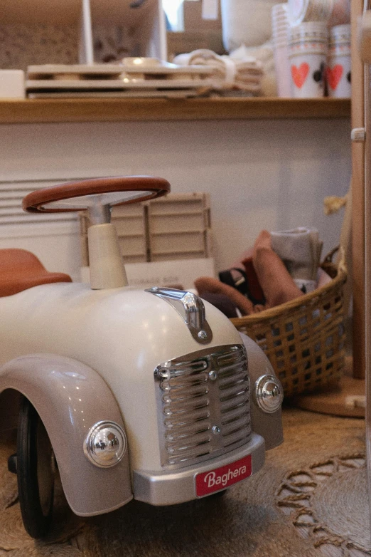 a toy car that is sitting on the floor, by Cornelisz Hendriksz Vroom, renaissance, quirky shops, beige, activity play centre, monaco