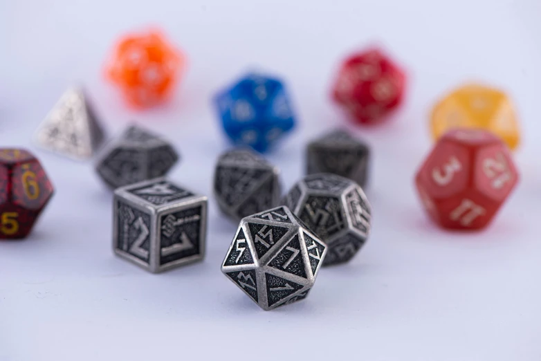 a bunch of dice sitting on top of a table, intricate metal, critical role, detailed product image, upscaled to high resolution