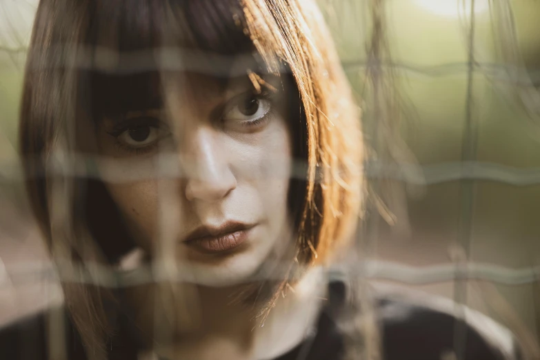 a close up of a person behind a fence, charli bowater, nouvelle vague, alessio albi, high quality image