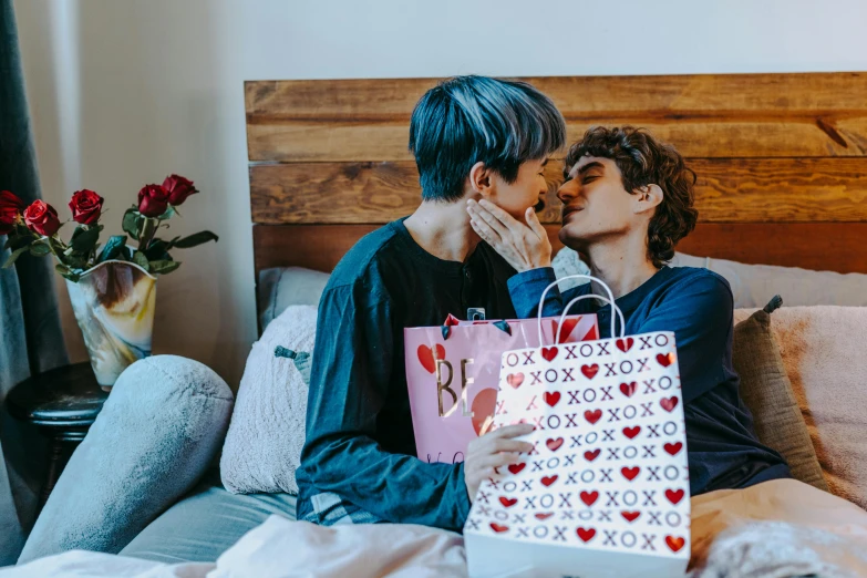 a man and a woman kissing on a bed, trending on pexels, holding gift, lgbt, ruan jia and brom, xqc