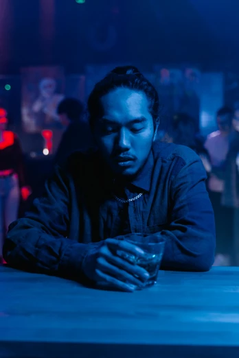 a man sitting at a bar with a drink in his hand, an album cover, inspired by Liam Wong, pexels contest winner, frank dillane, kendrick lamar, movie still, asian man