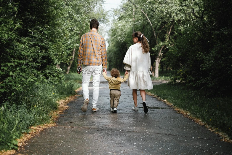 a man and woman walking down a road with a small child, pexels, renaissance, walking through the trees, handsome, paved, screensaver