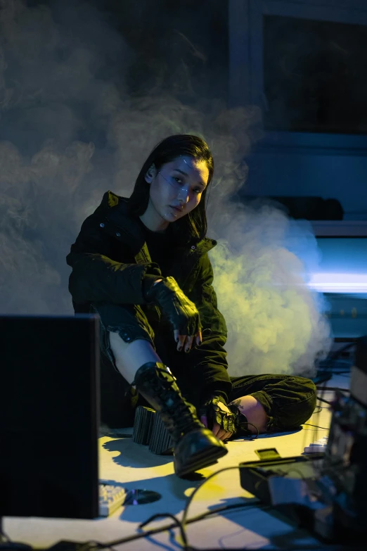 a woman sitting on the floor in front of a computer, cyberpunk art, inspired by Zhu Da, unsplash, wearing space techwear, kiko mizuhara, wearing apocalyptic clothes, techwear look and clothes
