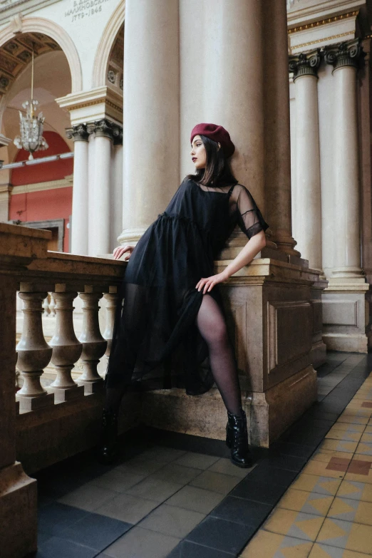 a woman in a black dress sitting on a balcony, pexels contest winner, baroque, witchcore clothes, sheer, mall goth, velvet stockings