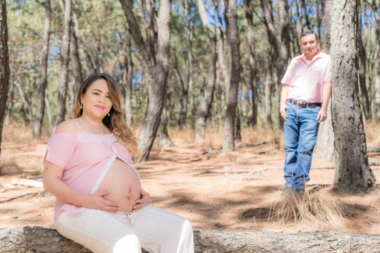 a pregnant woman sitting on a log next to a man, a portrait, by Julian Allen, instagram, portrait image, coloured photo, realistic », straya