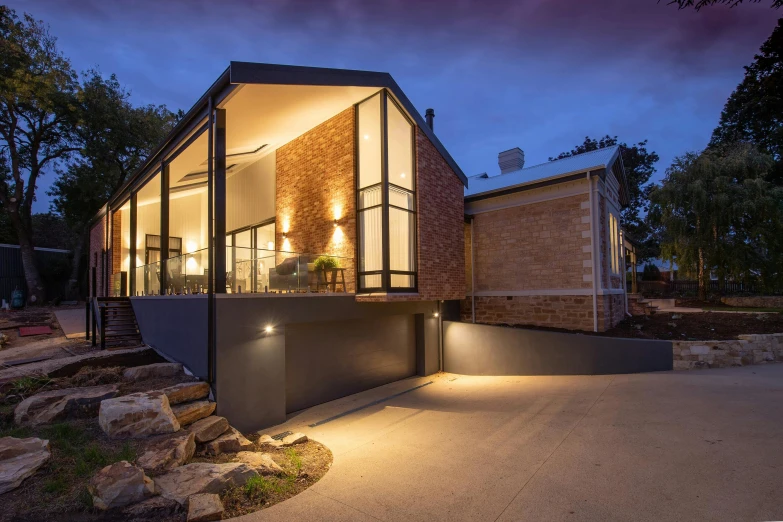 a house that is lit up at night, inspired by George Pirie, altermodern, stone and glass, award winning details, beautiful natural rim light, award winning masterpiece photo