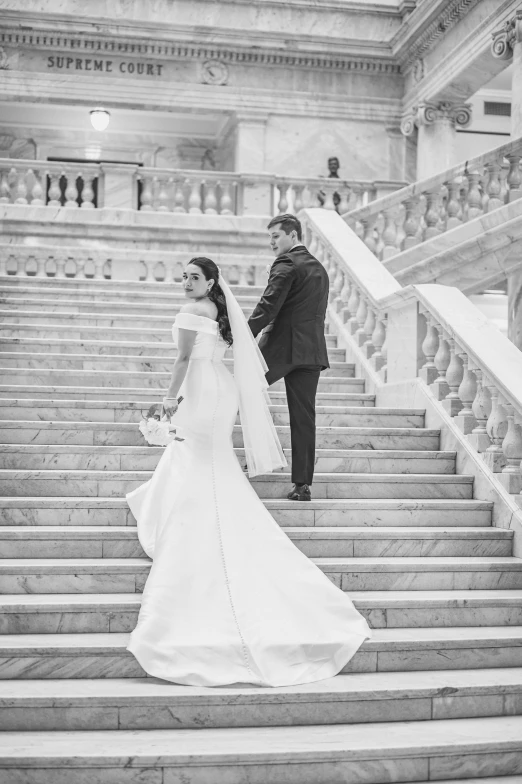 a bride and groom walking down a set of stairs, a black and white photo, by Anita Malfatti, pexels contest winner, 2 5 6 x 2 5 6 pixels, while marble, library of congress, michael wellen