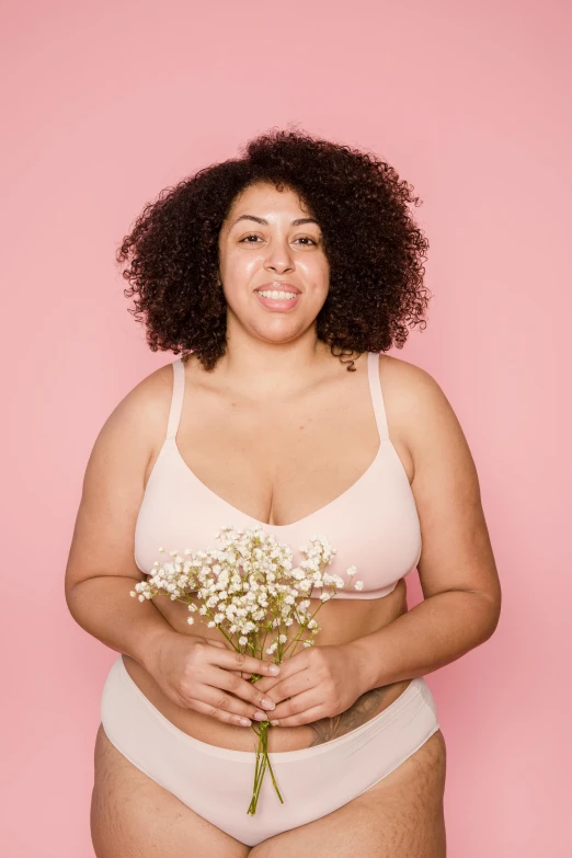 a woman in a white underwear holding a bouquet of flowers, in a black betch bra, plus-sized, an olive skinned, no makeup wavy hair