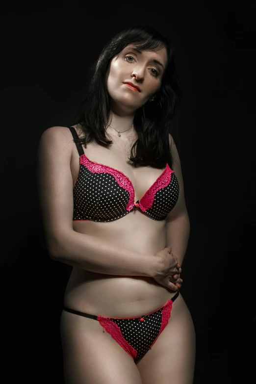 a woman in lingerie posing for a picture, pink and black, portait image, coloured photo, frontal shot