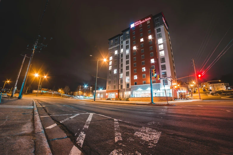 a tall building sitting on the side of a road, red and white lighting, ten flats, thumbnail, northern star at night