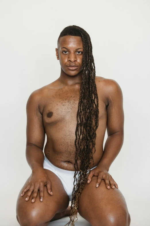 a man sitting on the ground with a chain around his neck, by Ellen Gallagher, featured on reddit, long cornrows, nonbinary model, set against a white background, wearing white leotard