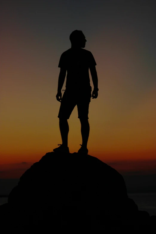 a man standing on top of a mountain at sunset, a statue, taken in the late 2010s, ((sunset)), myself