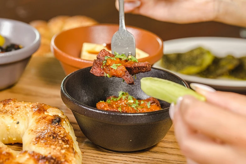 a wooden table topped with bowls of food, by Carey Morris, pexels contest winner, hurufiyya, mid action, meni chatzipanagiotou, paprika, great wings