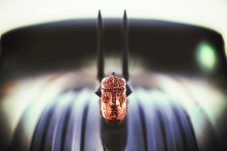 a close up of a car hood ornament, inspired by Hedi Xandt, unsplash, the buddha, medium format. soft light, sitting in front of a microphone, intricate copper details