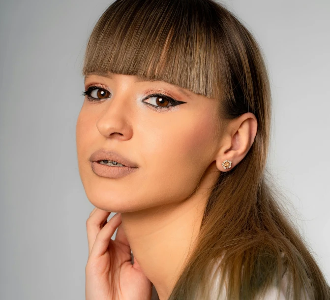 a woman with long hair posing for a picture, winged eyeliner, detailed product image, brown fringe, portrait sophie mudd