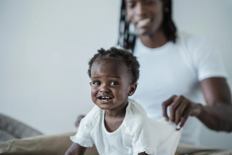 a woman brushing a child's teeth with a toothbrush, a picture, by Lee Loughridge, pexels contest winner, brown skin man with a giant grin, a still of a happy, taliyah, portrait of small