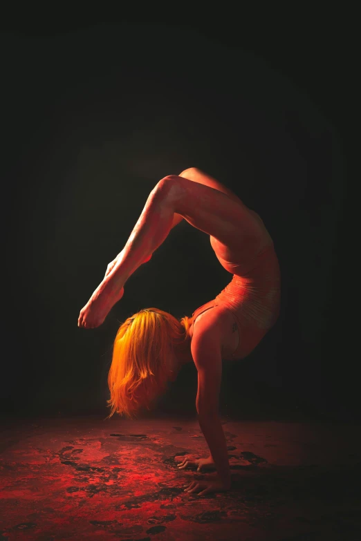 a woman doing a handstand in the dark, inspired by Brooke Shaden, figurative art, intense albino, orange and red lighting, photograph taken in 2 0 2 0, curved body