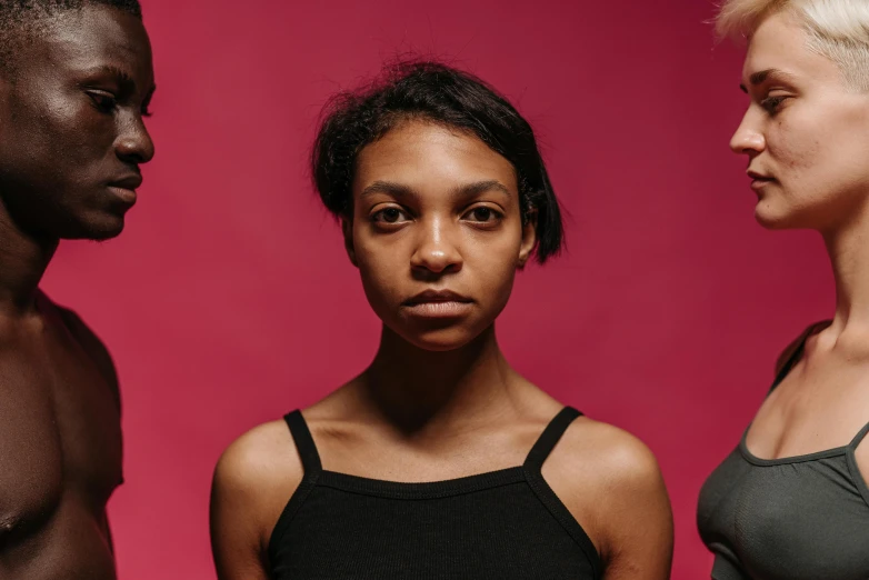 a group of people standing next to each other, an album cover, unsplash, antipodeans, black young woman, serious facial expression, portrait of two people, panel of black