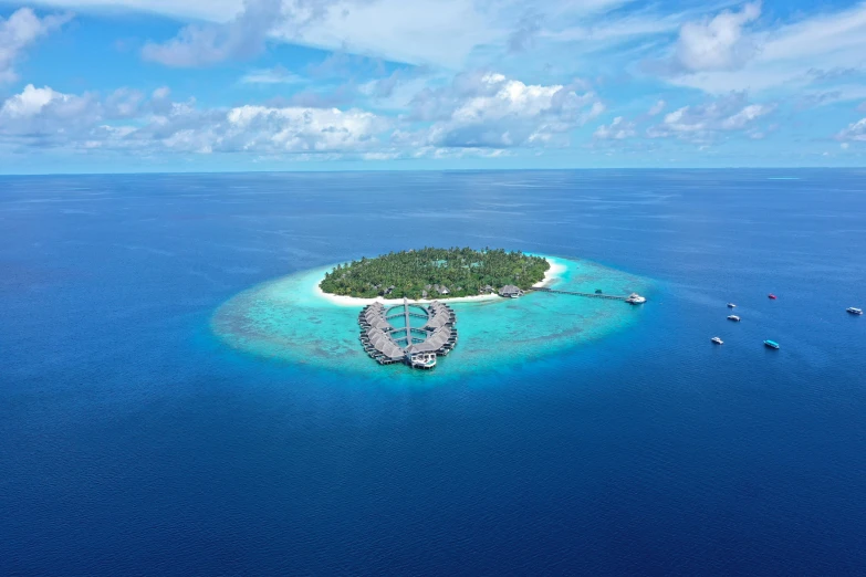 a small island in the middle of the ocean, by Julian Allen, pexels contest winner, hurufiyya, resort, award-winning masterpiece, grey, clear blue skies