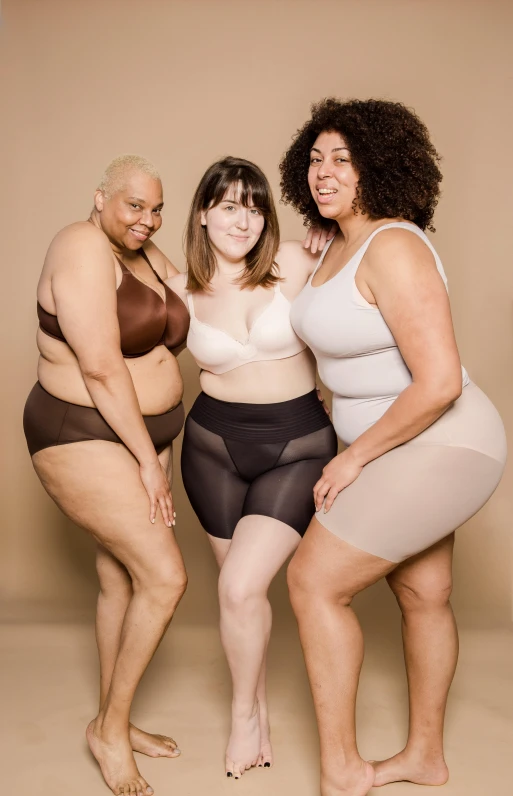 a group of women standing next to each other, inspired by Vanessa Beecroft, trending on pexels, an obese, muted browns, underwear ad, transparent