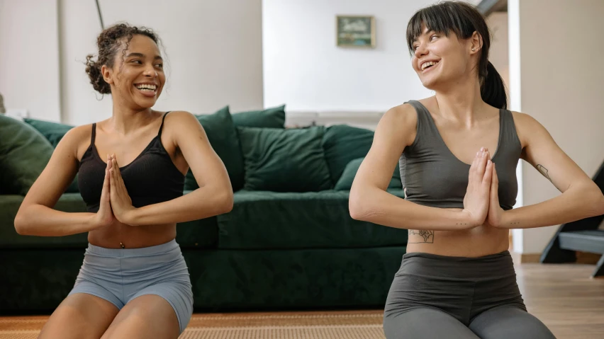 two women doing yoga in a living room, pexels contest winner, happening, physical : tinyest midriff ever, smiling laughing, avatar image, profile image