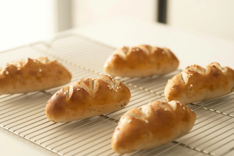 a bunch of bread sitting on top of a cooling rack, inspired by Richmond Barthé, 6 pack, mediterranean, petite, hasselblatt