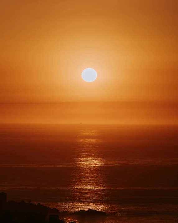 the sun is setting over a body of water, pexels contest winner, romanticism, orange gradient, ocean in distance, hot weather, sun shaft