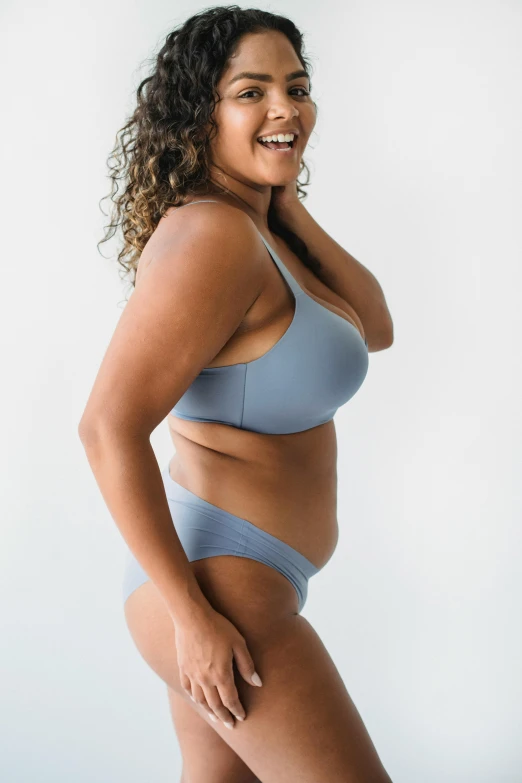 a woman in a blue bikini posing for a picture, flat grey color, profile image, rubenesque, full product shot