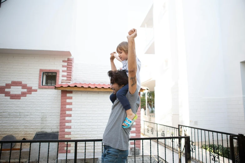 a couple of kids standing on top of a skateboard, pexels contest winner, figuration libre, father holds child in the hand, square, standing outside a house, grey