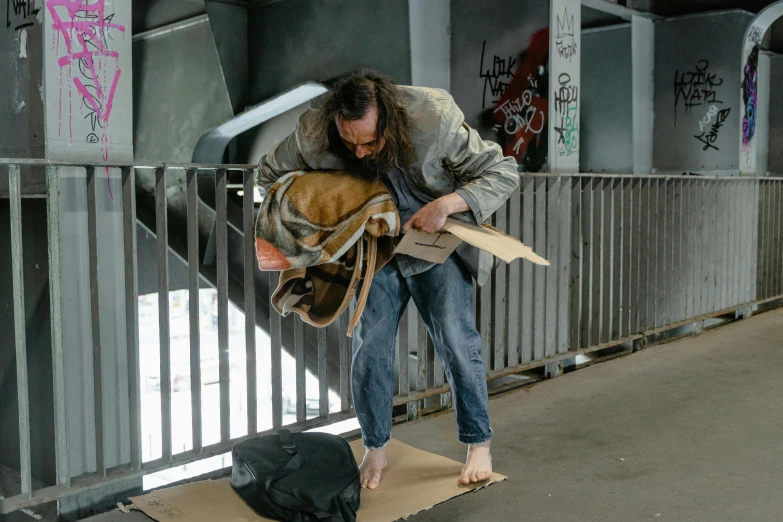 a man standing on top of a piece of cardboard, homeless, hyper - realistic, australian, brown