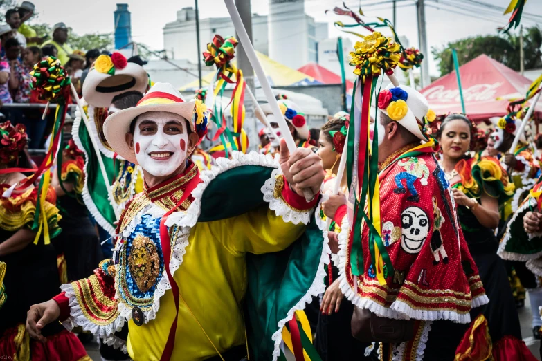 a group of people that are standing in the street, by Sam Dillemans, pexels contest winner, carnaval de barranquilla, wearing authentic attire, montreal, thumbnail