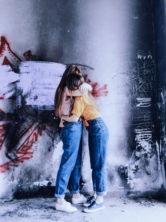 a couple of people that are standing in front of a wall, a picture, trending on pexels, lesbian embrace, grunge aesthetic!!! (, 15081959 21121991 01012000 4k, hugging her knees