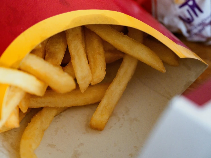 a bag of french fries sitting on top of a table, unsplash, photorealism, image of ronald mcdonald, frying nails, picnic, australian