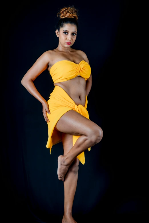 a woman in a yellow dress posing for a picture, by Leonard Daniels, art photography, fit curvy physique, sarong, bare leg, 15081959 21121991 01012000 4k