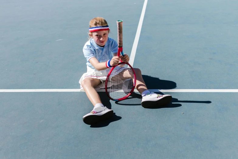 a young boy sitting on a tennis court holding a tennis racquet, by Anna Findlay, pexels contest winner, fancy dress, girl wearing uniform, top down shot, 15081959 21121991 01012000 4k