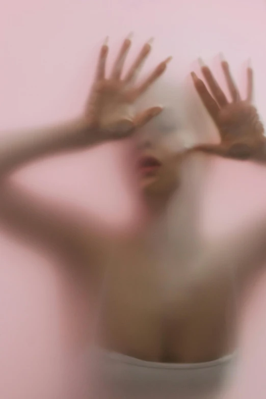 a blurry image of a woman covering her face with her hands, inspired by Ren Hang, pexels contest winner, conceptual art, faded pink, nick knight, floating in perfume, abstract figurative art