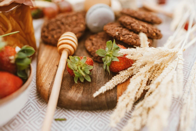 a wooden cutting board topped with strawberries and cookies, by Emma Andijewska, pexels contest winner, dried flowers, straw, picnic, profile image