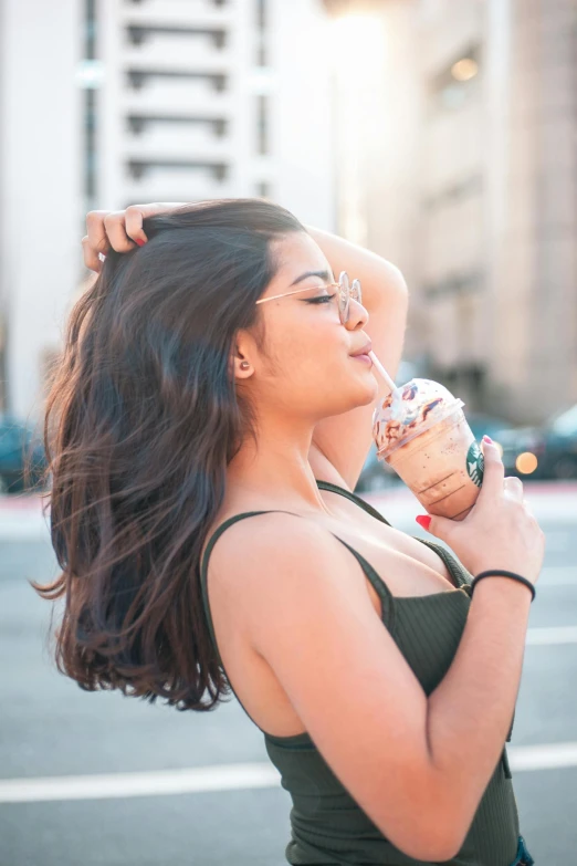 a woman eating an ice cream cone on a city street, a picture, trending on pexels, renaissance, sunny leone, wearing crop top, iced latte, headshot profile picture